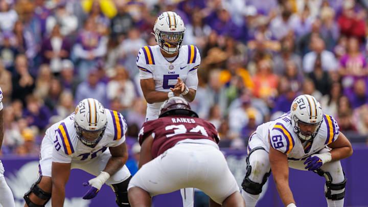 Nov 25, 2023; Baton Rouge, Louisiana, USA;  LSU Tigers quarterback Jayden Daniels (5) calls for the ball against Texas A&M Aggies defensive lineman Isaiah Raikes (34) during the second half at Tiger Stadium. Mandatory Credit: Stephen Lew-USA TODAY Sports