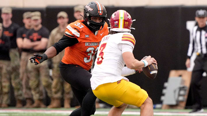 Oklahoma State's Kyran Duhon (33) pressures Iowa State's Rocco Becht (3) in the first half of the college football game between the Oklahoma State Cowboys and the Iowa State Cyclones at Boone Pickens Stadium in Stillwater, Okla., Saturday Nov. 29, 2025.
