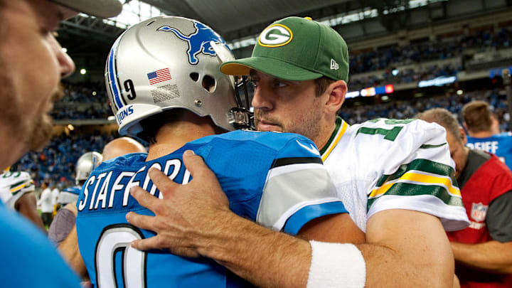 Sep 21, 2014; Detroit, MI, USA; Detroit Lions quarterback Matthew Stafford (9) and Green Bay Packers quarterback Aaron Rodgers (12) after the game at Ford Field. Detroit won 19-7. Mandatory Credit: Tim Fuller-Imagn Images