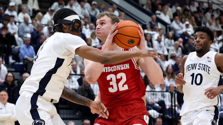 Jan 22, 2026; University Park, Pennsylvania, USA; Wisconsin Badgers forward Aleksas Bieliauskas (32) drives against Penn State Nittany Lions guard Kayden Mingo (4) during the first half at Rec Hall. Jan 22, 2026; University Park, Pennsylvania, USA; Wisconsin Badgers forward Aleksas Bieliauskas (32) drives against Penn State Nittany Lions guard Kayden Mingo (4) during the first half at Rec Hall.