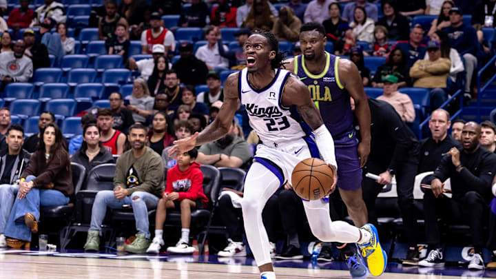 Feb 12, 2025; New Orleans, Louisiana, USA;  Sacramento Kings guard Keon Ellis (23) dribbles around New Orleans Pelicans forward Zion Williamson (1) during the first half at Smoothie King Center. Mandatory Credit: Stephen Lew-Imagn Images