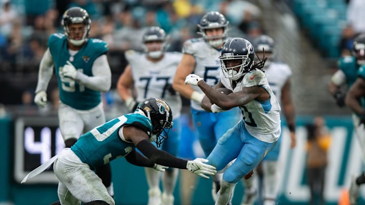 Dec 29, 2024; Jacksonville, Florida, USA; Tennessee Titans wide receiver Calvin Ridley (0) runs the ball after the catch against Jacksonville Jaguars cornerback Montaric Brown (30) in the fourth quarter at EverBank Stadium. Mandatory Credit: Jeremy Reper-Imagn Images