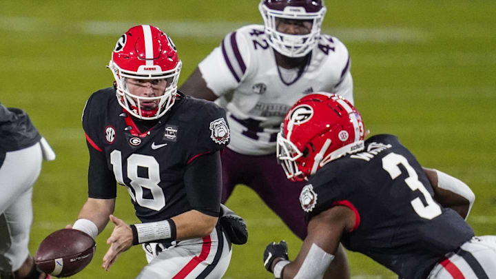 Nov 21, 2020; Athens, Georgia, USA; Georgia Bulldogs quarterback JT Daniels (18) hands the ball off to running back Zamir White (3) against the Mississippi State Bulldogs during the first quarter at Sanford Stadium. Mandatory Credit: Dale Zanine-Imagn Images