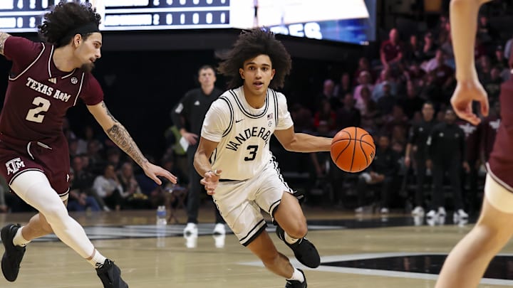 Feb 14, 2026; Nashville, Tennessee, USA; Vanderbilt Commodores guard Tyler Tanner (3)drives to the basket past Texas A&M Aggies guard Pop Isaacs (2) during the second half at Memorial Gymnasium. Mandatory Credit: Steve Roberts-Imagn Images