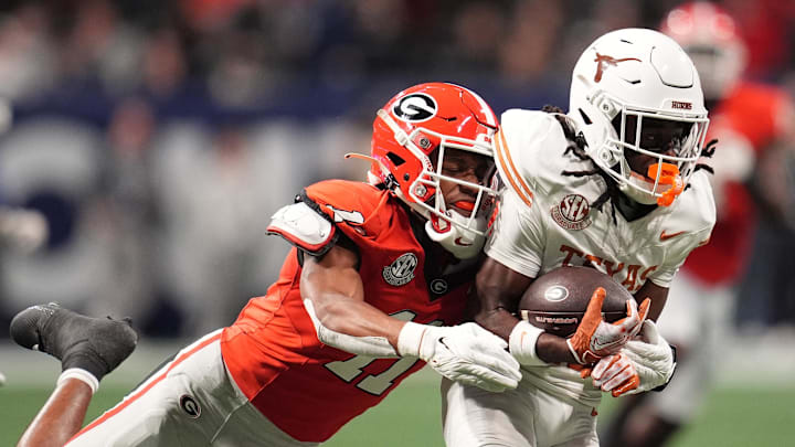 Dec 7, 2024; Atlanta, GA, USA; Texas Longhorns wide receiver Silas Bolden (11) makes a catch agaistn Georgia Bulldogs linebacker Jalon Walker (11) during the first half in the 2024 SEC Championship game at Mercedes-Benz Stadium. Mandatory Credit: Dale Zanine-Imagn Images