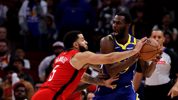 Nov 2, 2024; Houston, Texas, USA; Golden State Warriors forward Andrew Wiggins (22) handles the ball against Houston Rockets guard Fred VanVleet (5) during the game at Toyota Center. Mandatory Credit: Erik Williams-Imagn Images
