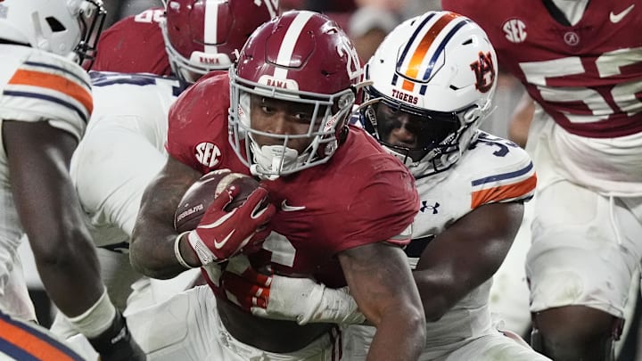 Nov 30, 2024; Tuscaloosa, Alabama, USA; Alabama Crimson Tide running back Jam Miller (26) is tackled by Auburn Tigers buck Jalen McLeod (35) during the second half at Bryant-Denny Stadium. Alabama won 28-14. Mandatory Credit: Gary Cosby Jr.-Imagn Images Nov 30, 2024; Tuscaloosa, Alabama, USA; Alabama Crimson Tide running back Jam Miller (26) is tackled by Auburn Tigers buck Jalen McLeod (35) during the second half at Bryant-Denny Stadium. Alabama won 28-14. Mandatory Credit: Gary Cosby Jr.-Imagn Images
