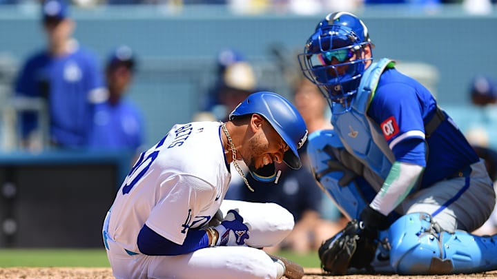 Jun 16, 2024; Los Angeles, California, USA; Los Angeles Dodgers shortstop Mookie Betts (50) reacts after being hit by pitch from Kansas City Royals pitcher Dan Altavilla (54) during the seventh inning at Dodger Stadium. Mandatory Credit: Gary A. Vasquez-USA TODAY Sports