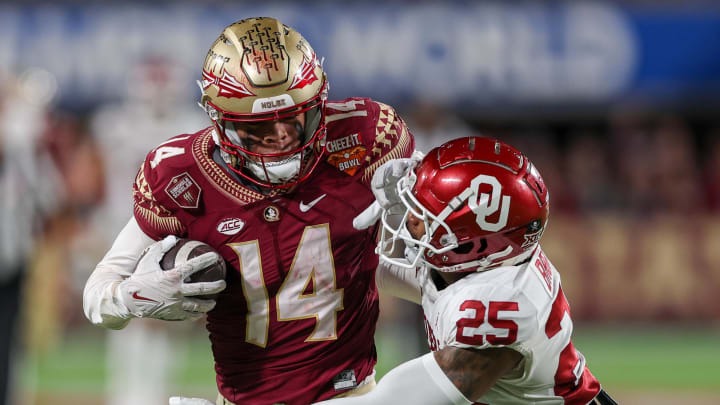 Dec 29, 2022; Orlando, Florida, USA; Florida State Seminoles wide receiver Johnny Wilson (14) catches a pass while defended by Oklahoma Sooners defensive back Justin Broiles (25) in the fourth quarter during the 2022 Cheez-It Bowl at Camping World Stadium. Mandatory Credit: Nathan Ray Seebeck-USA TODAY Sports Dec 29, 2022; Orlando, Florida, USA; Florida State Seminoles wide receiver Johnny Wilson (14) catches a pass while defended by Oklahoma Sooners defensive back Justin Broiles (25) in the fourth quarter during the 2022 Cheez-It Bowl at Camping World Stadium. Mandatory Credit: Nathan Ray Seebeck-USA TODAY Sports