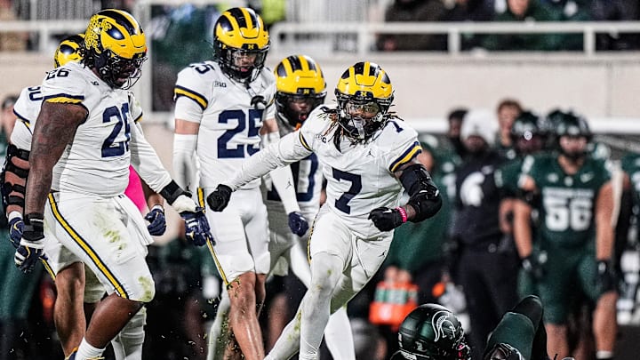 Michigan defensive back TJ Metcalf (7) celebrates a tackle against Michigan State wide receiver Chrishon McCray (13) during the second half at Spartan Stadium in East Lansing on Saturday, October 25, 2025.