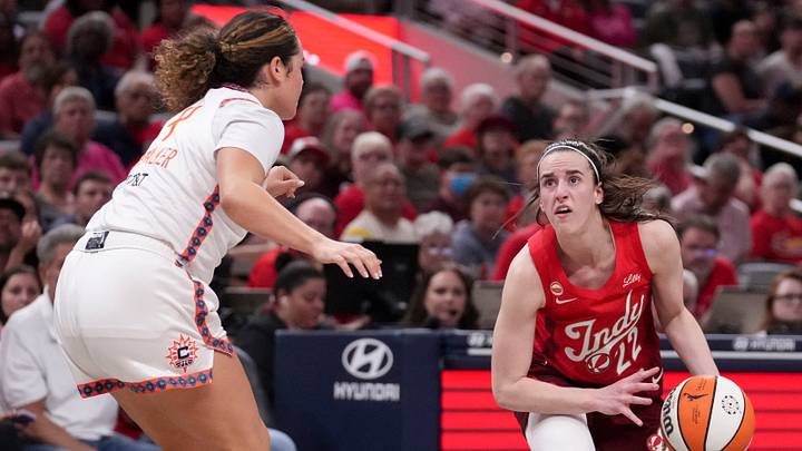 Connecticut Sun guard Charlisse Leger-Walker (4) defends Indiana Fever guard Caitlin Clark (22) as she looks to shoot during a game on Friday, Aug. 28, 2026, at Gainbridge Fieldhouse in Indianapolis. The Fever defeated the Sun 111-91.