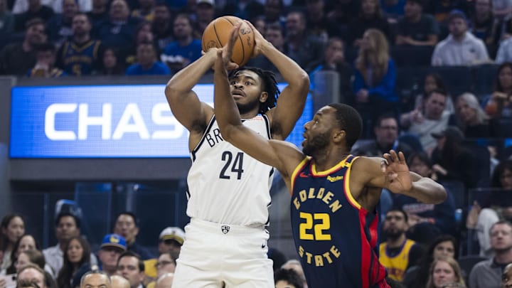 Nov 25, 2024; San Francisco, California, USA; Golden State Warriors forward Andrew Wiggins (22) defends against a shot by Brooklyn Nets guard Cam Thomas (24)during the first half at Chase Center. Mandatory Credit: John Hefti-Imagn Images