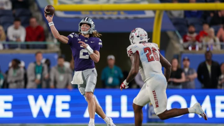 Dec 28, 2023; Orlando, FL, USA; Kansas State Wildcats quarterback Avery Johnson (2) throws a pass guarded by North Carolina State Wolfpack linebacker Devon Betty (26) in the fourth quarter during the Pop-Tarts bowl at Camping World Stadium. Mandatory Credit: Nathan Ray Seebeck-USA TODAY Sports Dec 28, 2023; Orlando, FL, USA; Kansas State Wildcats quarterback Avery Johnson (2) throws a pass guarded by North Carolina State Wolfpack linebacker Devon Betty (26) in the fourth quarter during the Pop-Tarts bowl at Camping World Stadium. Mandatory Credit: Nathan Ray Seebeck-USA TODAY Sports