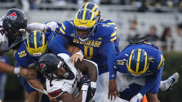 Delaware's Nick Karika (98) Q'yaeir Price (0) and K.T. Seay tackle Penn running back Malachi Hosley in the second quarter at Delaware Stadium, Saturday, Sept. 21, 2024.
