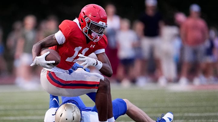 Brentwood Academy's Kesean Bowman (11) is pulled down by Brentwood's Mason Ball (6) during the first half at Brentwood Academy in Brentwood, Tenn., Friday, Aug. 30, 2024.