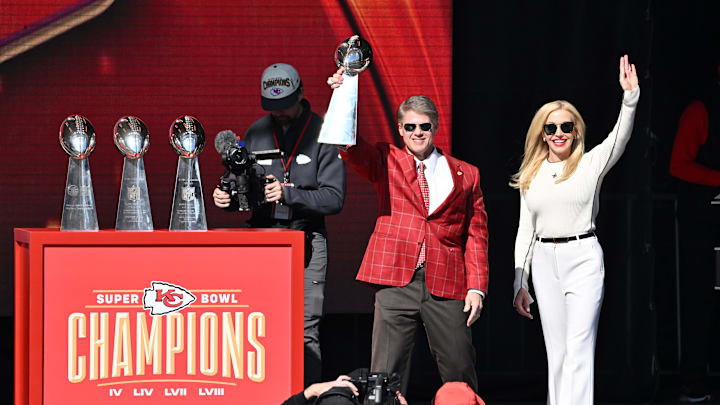 Feb 14, 2024; Kansas City, MO, USA; Kansas City Chiefs chairman and co-owner Clark Hunt holds the Vince Lombardi Trophy on stage with his wife Tavia during the celebration of the Kansas City Chiefs winning Super Bowl LVIII. Mandatory Credit: David Rainey-Imagn Images