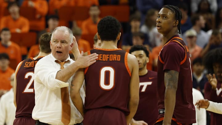 Mar 7, 2026; Charlottesville, Virginia, USA; Virginia Tech Hokies head coach Mike Young (L) encourages Virginia Tech Hokies guard Jailen Bedford (0) during a time against the Virginia Cavaliers in the second half at John Paul Jones Arena. Mandatory Credit: Geoff Burke-Imagn Images