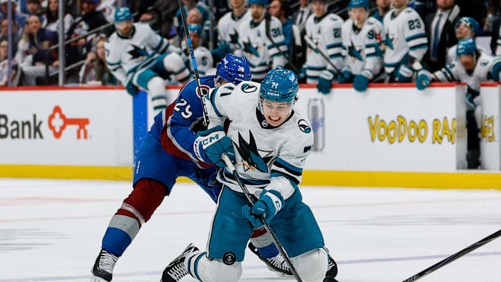 Feb 4, 2026; Denver, Colorado, USA; Colorado Avalanche center Nathan MacKinnon (29) pushes San Jose Sharks center MacKlin Celebrini (71) off the puck in the third period at Ball Arena. Mandatory Credit: Isaiah J. Downing-Imagn Images