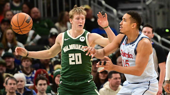 Dec 21, 2024; Milwaukee, Wisconsin, USA;  Washington Wizards guard Malcolm Brogdon (15) passes the ball against Milwaukee Bucks guard AJ Green (20) in the second quarter at Fiserv Forum. Mandatory Credit: Benny Sieu-Imagn Images