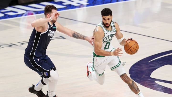 Jun 14, 2024; Dallas, Texas, USA; Boston Celtics forward Jayson Tatum (0) dribbles the ball against Dallas Mavericks guard Luka Doncic (77) during the second quarter during game four of the 2024 NBA Finals at American Airlines Center. Mandatory Credit: Peter Casey-USA TODAY Sports Jun 14, 2024; Dallas, Texas, USA; Boston Celtics forward Jayson Tatum (0) dribbles the ball against Dallas Mavericks guard Luka Doncic (77) during the second quarter during game four of the 2024 NBA Finals at American Airlines Center. Mandatory Credit: Peter Casey-USA TODAY Sports