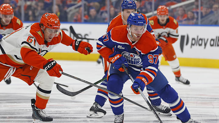 Apr 22, 2026; Edmonton, Alberta, CAN; Anaheim Ducks forward Cutter Gauthier (61) tries to knock the puck away from Edmonton Oilers forward Connor McDavid (97) during the first period in game two of the first round of the 2026 Stanley Cup Playoffs at Rogers Place. Mandatory Credit: Perry Nelson-Imagn Images