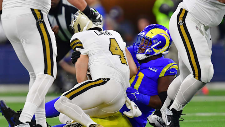 Dec 21, 2023; Inglewood, California, USA; New Orleans Saints quarterback Derek Carr (4) is brought