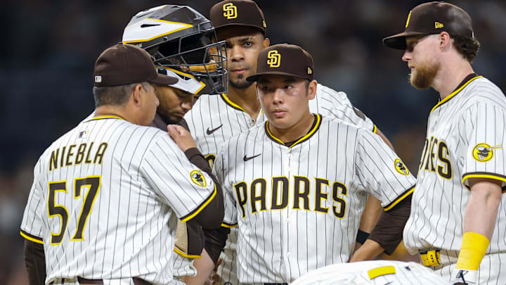 May 31, 2025; San Diego, California, USA; San Diego Padres pitching coach Ruben Niebla (57) meets with San Diego Padres relief pitcher Yuki Matsui (1) during the seventh inning against the Pittsburgh Pirates at Petco Park. Mandatory Credit: David Frerker-Imagn Images