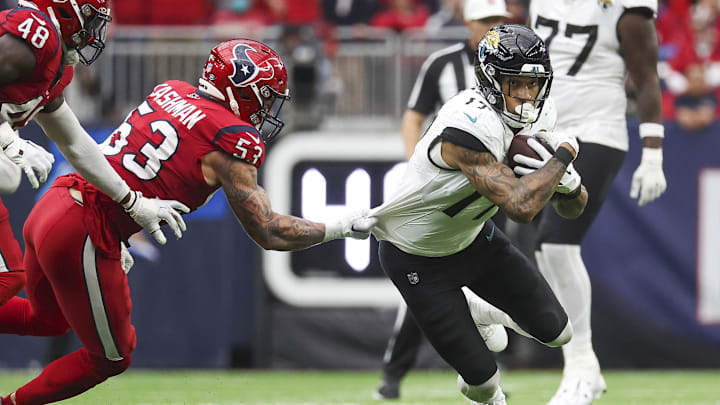 Nov 26, 2023; Houston, Texas, USA; Houston Texans linebacker Blake Cashman (53) attempts to tackle Jacksonville Jaguars tight end Evan Engram (17) during the fourth quarter at NRG Stadium. Mandatory Credit: Troy Taormina-Imagn Images