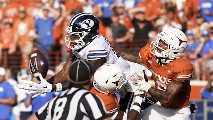 BYU Cougars wide receiver Darius Lassiter draws a penalty during a play against Texas Longhorns defensive back Derek Williams Jr. and defensive back Ryan Watts during the second half at Darrell K Royal-Texas Memorial Stadium. BYU Cougars wide receiver Darius Lassiter draws a penalty during a play against Texas Longhorns defensive back Derek Williams Jr. and defensive back Ryan Watts during the second half at Darrell K Royal-Texas Memorial Stadium.