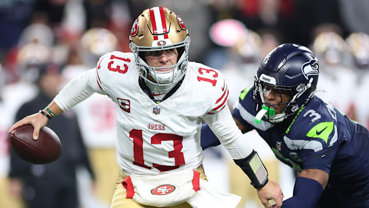 San Francisco 49ers quarterback Brock Purdy (13) is chased by Seattle Seahawks safety Nick Emmanwori (3)