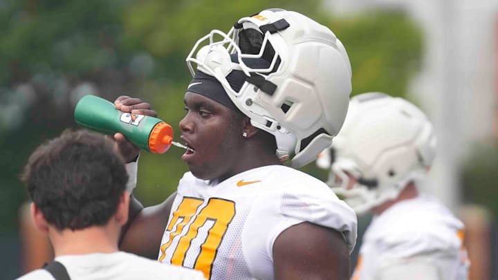 Tennessee offensive lineman David Sanders Jr. (70) drinks water during Tennessee football preseason practice, in Knoxville, Tennessee, July 31, 2025.