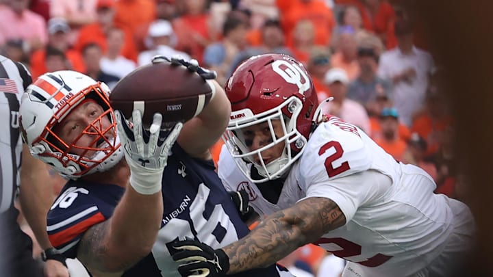 Sep 28, 2024; Auburn, Alabama, USA;  Auburn Tigers tight end Luke Deal (86) catches a pass for a touchdown as Oklahoma Sooners defensive back Billy Bowman Jr. (2) defends during the fourth quarter at Jordan-Hare Stadium. Mandatory Credit: John Reed-Imagn Images