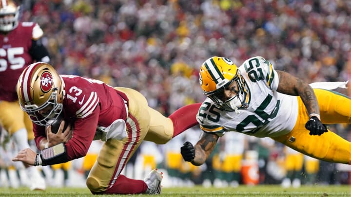 January 20, 2024; Santa Clara, CA, USA; San Francisco 49ers quarterback Brock Purdy (13) runs against Green Bay Packers cornerback Keisean Nixon (25) during the fourth quarter in a 2024 NFC divisional round game at Levi's Stadium. Mandatory Credit: Kyle Terada-USA TODAY Sports