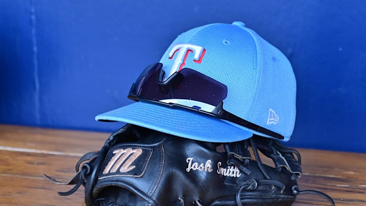 Mar 15, 2024; Salt River Pima-Maricopa, Arizona, USA; General view of a Texas Rangers hat, glove, and glasses prior to a spring training game against the Colorado Rockies at Salt River Fields at Talking Stick. Mandatory Credit: Matt Kartozian-Imagn Images Mar 15, 2024; Salt River Pima-Maricopa, Arizona, USA; General view of a Texas Rangers hat, glove, and glasses prior to a spring training game against the Colorado Rockies at Salt River Fields at Talking Stick. Mandatory Credit: Matt Kartozian-Imagn Images