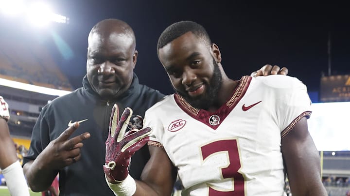 Nov 4, 2023; Pittsburgh, Pennsylvania, USA;  Florida State Seminoles running backs coach David Johnson (left) and running back Trey Benson (3) react as they leave the field after defeating the Pittsburgh Panthers at Acrisure Stadium. The Seminoles won 24-7. Mandatory Credit: Charles LeClaire-Imagn Images