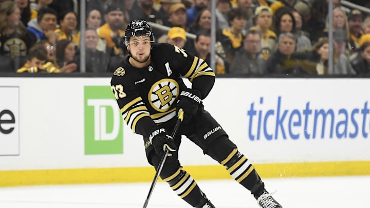 May 12, 2024; Boston, Massachusetts, USA; Boston Bruins defenseman Charlie McAvoy (73) controls the puck during the first period in game four of the second round of the 2024 Stanley Cup Playoffs against the Florida Panthers at TD Garden. Mandatory Credit: Bob DeChiara-Imagn Images