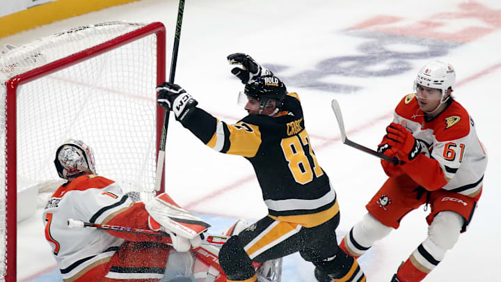 Oct 31, 2024; Pittsburgh, Pennsylvania, USA;  Pittsburgh Penguins center Sidney Crosby (87) reacts after scoring the game winning goal against Anaheim Ducks goaltender Lukas Dostal (1) in overtime at PPG Paints Arena. Mandatory Credit: Charles LeClaire-Imagn Images