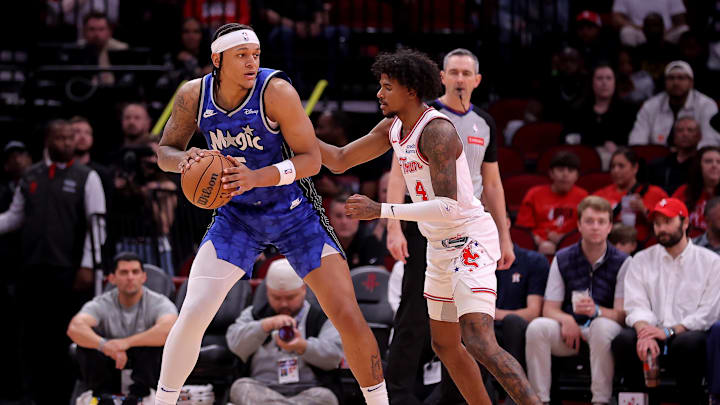 Apr 9, 2024; Houston, Texas, USA; Orlando Magic forward Paolo Banchero (5) handles the ball against Houston Rockets guard Jalen Green (4) during the first quarter at Toyota Center. Mandatory Credit: Erik Williams-Imagn Images