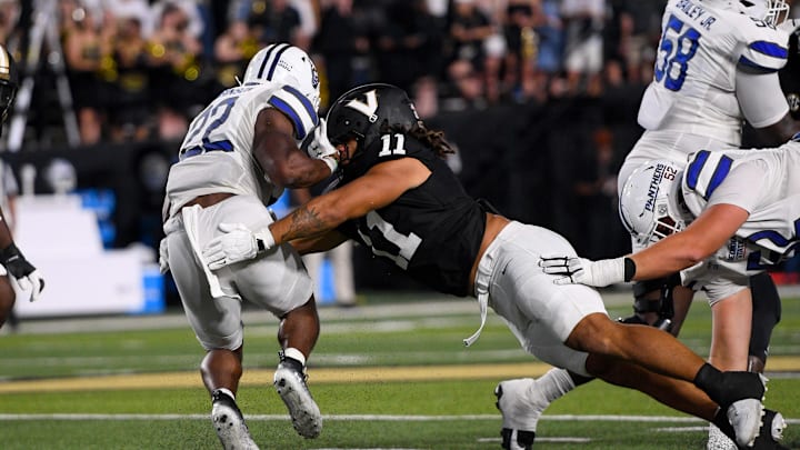 Sep 20, 2025; Nashville, Tennessee, USA;  Vanderbilt Commodores linebacker Bryan Longwell (11) tackles Georgia State Panthers running back Branson Robinson (22) during the first half at FirstBank Stadium. Mandatory Credit: Steve Roberts-Imagn Images