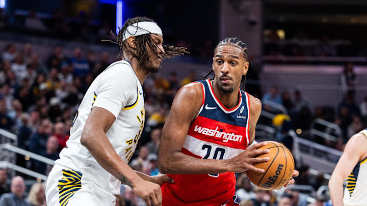 Apr 8, 2025; Indianapolis, Indiana, USA; Washington Wizards forward Alex Sarr (20) dribbles the ball while Indiana Pacers center Myles Turner (33)  defends in the second half at Gainbridge Fieldhouse. Mandatory Credit: Trevor Ruszkowski-Imagn Images
