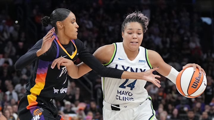 Sep 26, 2025; Phoenix, Arizona, USA; Minnesota Lynx forward Napheesa Collier (24) drives the ball against Phoenix Mercury forward DeWanna Bonner (14) during game three of the second round for the 2025 WNBA Playoffs at PHX Arena. Mandatory Credit: Rick Scuteri-Imagn Images