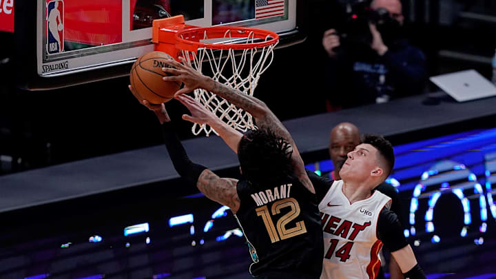 Apr 6, 2021; Miami, Florida, USA; Miami Heat guard Tyler Herro (14) fouls Memphis Grizzlies guard Ja Morant (12) during the first half at American Airlines Arena. Mandatory Credit: Jasen Vinlove-Imagn Images