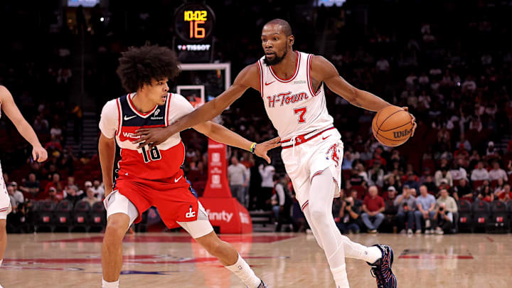 Nov 12, 2025; Houston, Texas, USA; Houston Rockets forward Kevin Durant (7) handles the ball against Washington Wizards forward Kyshawn George (18) during the first quarter at Toyota Center. Mandatory Credit: Erik Williams-Imagn Images