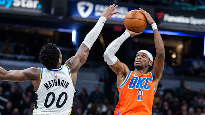 Dec 26, 2024; Indianapolis, Indiana, USA; Oklahoma City Thunder guard Shai Gilgeous-Alexander (2) shoots the ball while Indiana Pacers guard Bennedict Mathurin (00) defends in the second half at Gainbridge Fieldhouse. Mandatory Credit: Trevor Ruszkowski-Imagn Images