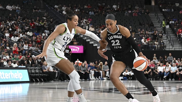 Sep 4, 2025; Las Vegas, Nevada, USA; Las Vegas Aces center A'ja Wilson (22) drives past Minnesota Lynx forward Napheesa Collier (24) in the first quarter of their game at T-Mobile Arena. Mandatory Credit: Candice Ward-Imagn Images