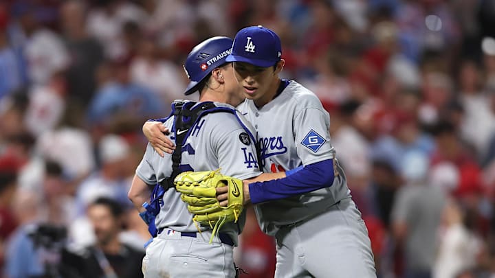 Oct 4, 2025; Philadelphia, Pennsylvania, USA; Los Angeles Dodgers pitcher Roki Sasaki (11) and catcher Will Smith (16) celebrate after defeating the Philadelphia Phillies in  game one of the NLDS round for the 2025 MLB playoffs at Citizens Bank Park.Mandatory Credit: Bill Streicher-Imagn Images