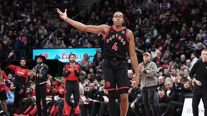 Dec 7, 2024; Toronto, Ontario, CAN; Toronto Raptors forward Scottie Barnes (4) reacts after scoring a three point basket against the Dallas Mavericks during the fourth quarter at Scotiabank Arena. Mandatory Credit: Nick Turchiaro-Imagn Images