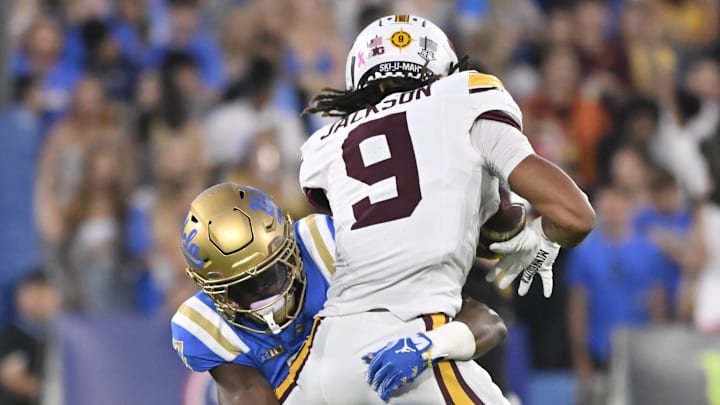 Oct 12, 2024; Pasadena, California, USA; UCLA Bruins defensive back K.J. Wallace (7) stops Minnesota Golden Gophers wide receiver Daniel Jackson (9) during the first quarter at Rose Bowl. Mandatory Credit: Robert Hanashiro-Imagn Images Oct 12, 2024; Pasadena, California, USA; UCLA Bruins defensive back K.J. Wallace (7) stops Minnesota Golden Gophers wide receiver Daniel Jackson (9) during the first quarter at Rose Bowl. Mandatory Credit: Robert Hanashiro-Imagn Images