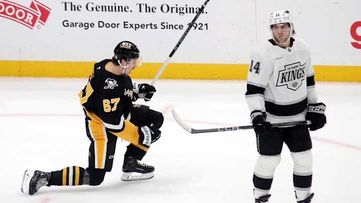Dec 17, 2024; Pittsburgh, Pennsylvania, USA;  Pittsburgh Penguins right wing Rickard Rakell (67) reacts after scoring the game winning goal in overtime against the Los Angeles Kings at PPG Paints Arena. Mandatory Credit: Charles LeClaire-Imagn Images