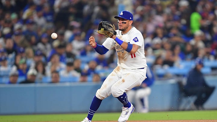 Sep 24, 2024; Los Angeles, California, USA; Los Angeles Dodgers shortstop Miguel Rojas (11) fields the ground ball of San Diego Padres third baseman Manny Machado (13) during the sixth inning at Dodger Stadium. Mandatory Credit: Gary A. Vasquez-Imagn Images Sep 24, 2024; Los Angeles, California, USA; Los Angeles Dodgers shortstop Miguel Rojas (11) fields the ground ball of San Diego Padres third baseman Manny Machado (13) during the sixth inning at Dodger Stadium. Mandatory Credit: Gary A. Vasquez-Imagn Images